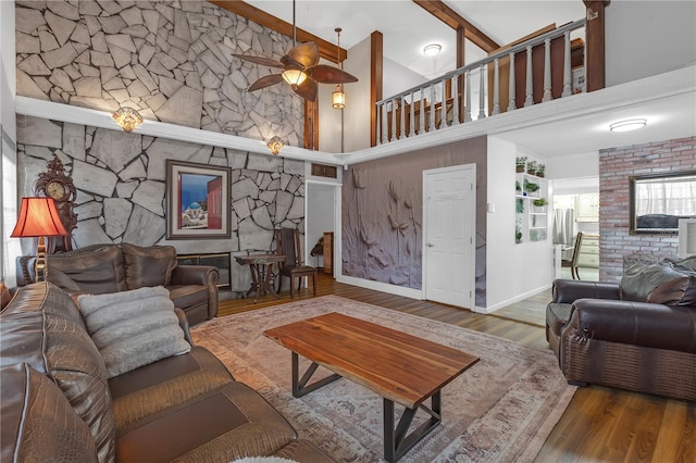 2014 E Broad St, Tampa, FL 33610 - living area with ceiling fan, beam ceiling, wood finished floors, high vaulted ceiling, and baseboards