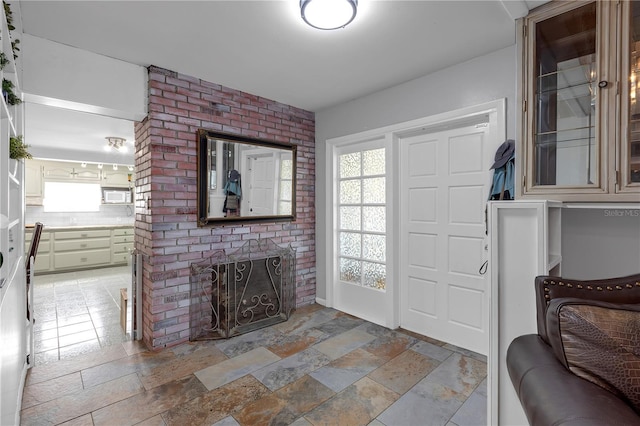 2014 E Broad St, Tampa, FL 33610 - entryway with a brick fireplace and stone tile floors
