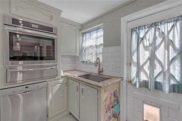 2014 E Broad St, Tampa, FL 33610 - kitchen featuring a sink, light countertops, stainless steel appliances, backsplash, and a warming drawer