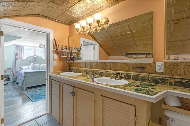 2014 E Broad St, Tampa, FL 33610 - ensuite bathroom featuring a sink, an ornate ceiling, double vanity, and lofted ceiling