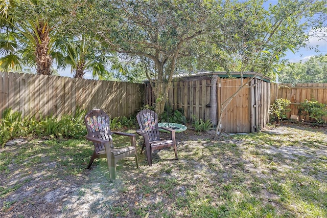 2014 E Broad St, Tampa, FL 33610 - view of yard featuring a storage shed, an outdoor structure, and a fenced backyard