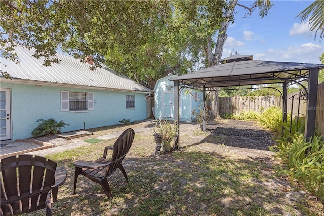 2014 E Broad St, Tampa, FL 33610 - view of yard featuring a gazebo, a shed, a fenced backyard, a detached carport, and an outdoor structure