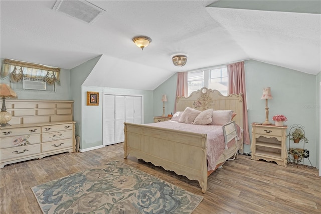 2014 E Broad St, Tampa, FL 33610 - bedroom with a textured ceiling, visible vents, wood finished floors, and vaulted ceiling