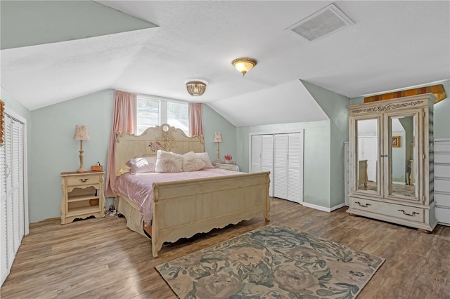2014 E Broad St, Tampa, FL 33610 - bedroom featuring a textured ceiling, vaulted ceiling, wood finished floors, and visible vents