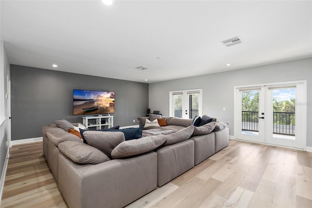 living area featuring recessed lighting, visible vents, french doors, and light wood-type flooring