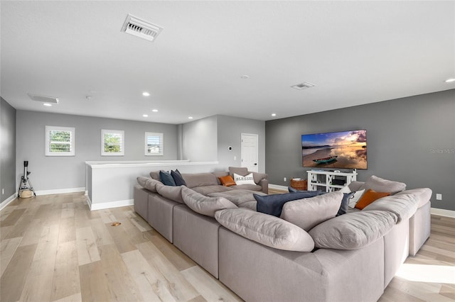 living area with recessed lighting, baseboards, visible vents, and light wood finished floors
