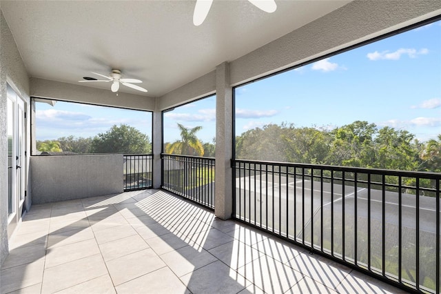 unfurnished sunroom featuring ceiling fan