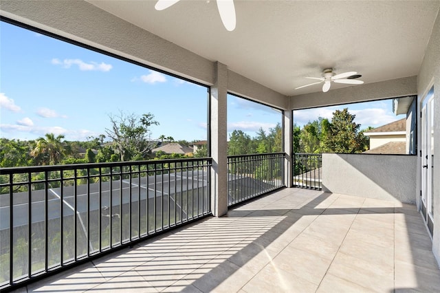 unfurnished sunroom featuring a ceiling fan