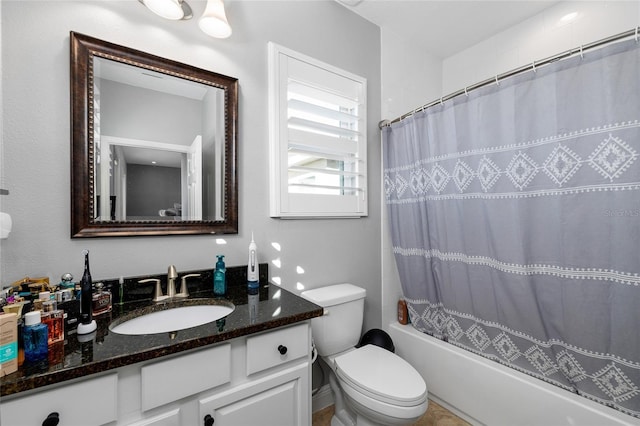 full bathroom featuring vanity, shower / bath combo, and toilet