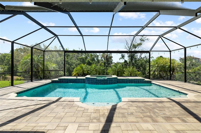 view of swimming pool with a pool with connected hot tub, a lanai, and a patio area