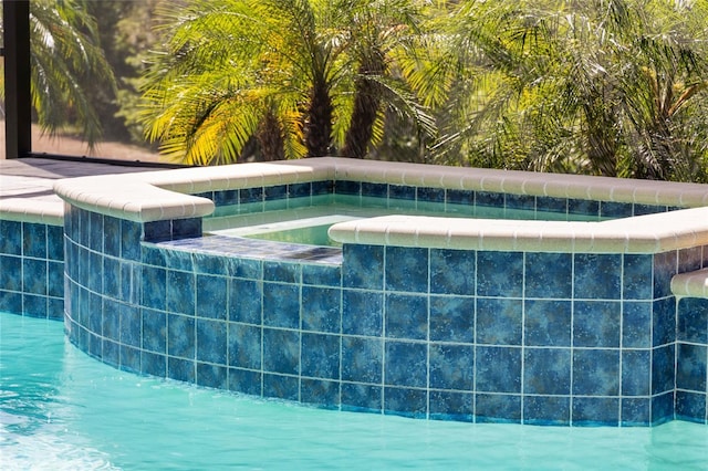 view of swimming pool featuring a pool with connected hot tub