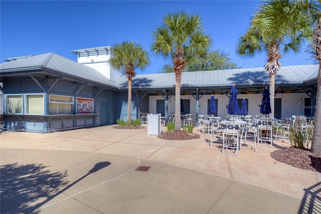 back of property featuring metal roof and a patio area