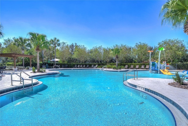 community pool featuring fence, a pergola, and a patio