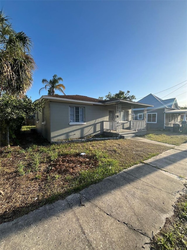 single story home featuring covered porch