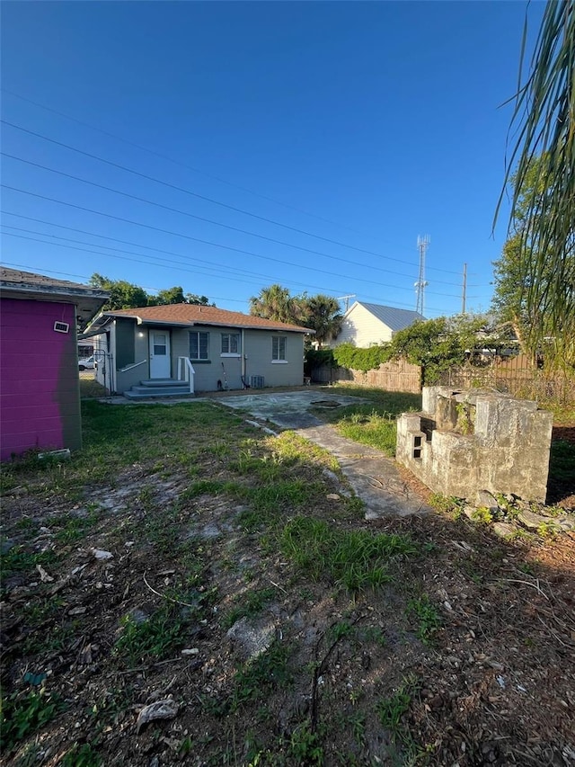 rear view of property with fence