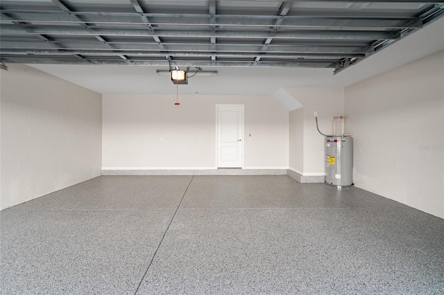 garage featuring concrete block wall, electric water heater, and a garage door opener