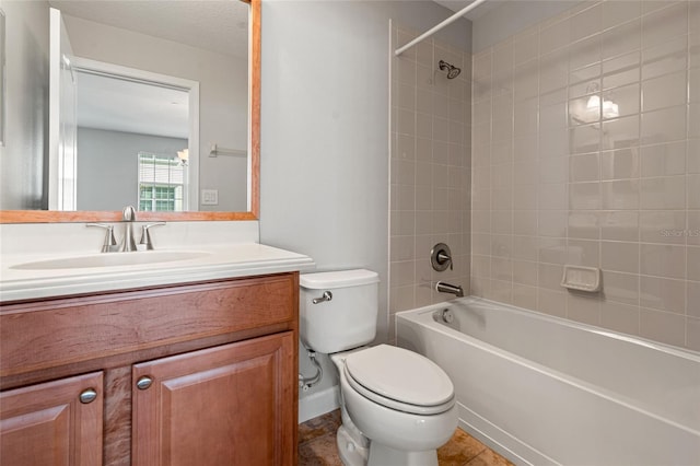 bathroom featuring toilet, vanity, and bathtub / shower combination