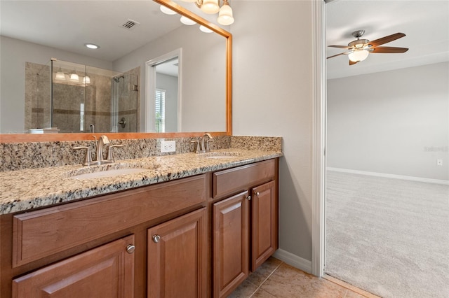 bathroom featuring a shower stall, a ceiling fan, a sink, and double vanity