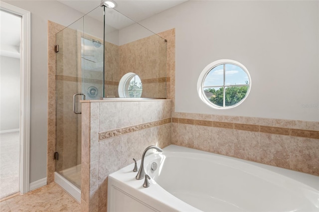 bathroom with a bath and a shower stall