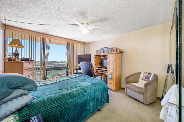 1 Key Capri Unit 608E, Treasure Island, FL 33706 - bedroom featuring light carpet, an office area, ceiling fan, and a textured ceiling