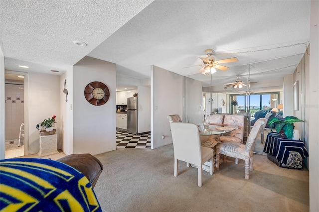 1 Key Capri Unit 608E, Treasure Island, FL 33706 - dining room with carpet, a textured ceiling, and ceiling fan