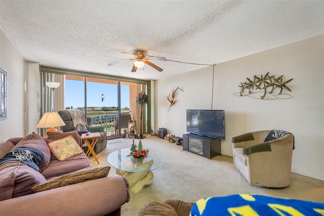 1 Key Capri Unit 608E, Treasure Island, FL 33706 - living area with a ceiling fan, carpet floors, and a textured ceiling