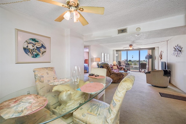 1 Key Capri Unit 608E, Treasure Island, FL 33706 - dining area featuring a ceiling fan, a textured ceiling, and carpet floors