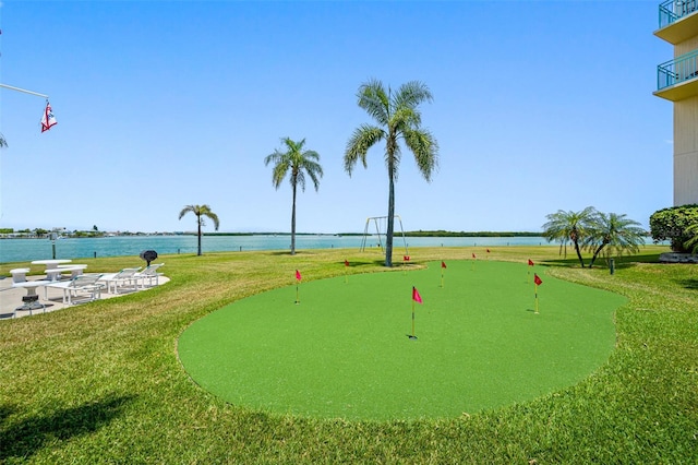 1 Key Capri Unit 608E, Treasure Island, FL 33706 - view of property's community featuring a putting area, a water view, and a yard