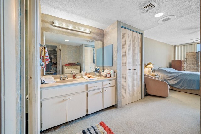 1 Key Capri Unit 608E, Treasure Island, FL 33706 - bathroom featuring a closet, a textured ceiling, and vanity