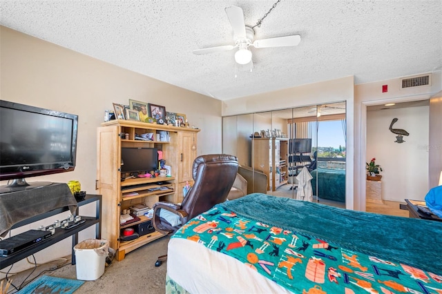 1 Key Capri Unit 608E, Treasure Island, FL 33706 - bedroom featuring a textured ceiling and a ceiling fan
