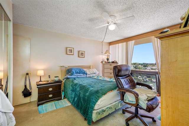 1 Key Capri Unit 608E, Treasure Island, FL 33706 - bedroom featuring carpet flooring, a textured ceiling, and ceiling fan