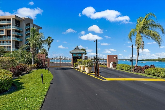 1 Key Capri Unit 608E, Treasure Island, FL 33706 - view of asphalt street featuring a gate, a gated entry, and street lights