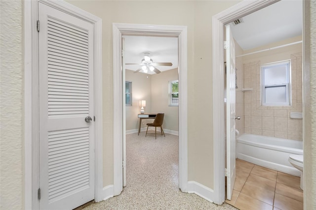 hall featuring baseboards and visible vents