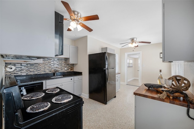 kitchen with a sink, light speckled floor, decorative backsplash, ceiling fan, and black appliances