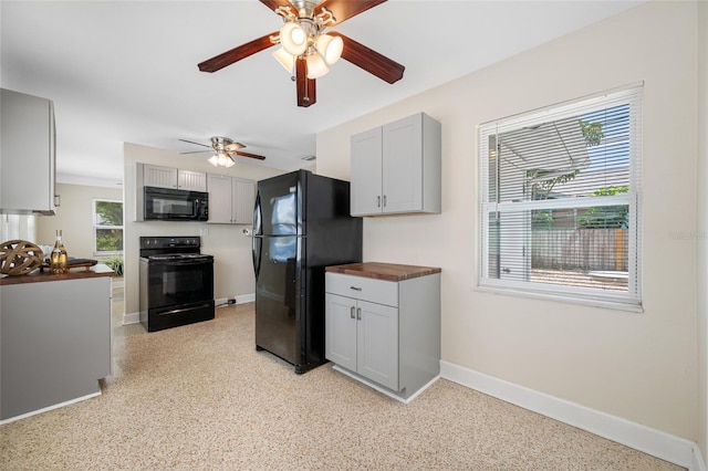 kitchen featuring black appliances, light speckled floor, wood counters, and a ceiling fan