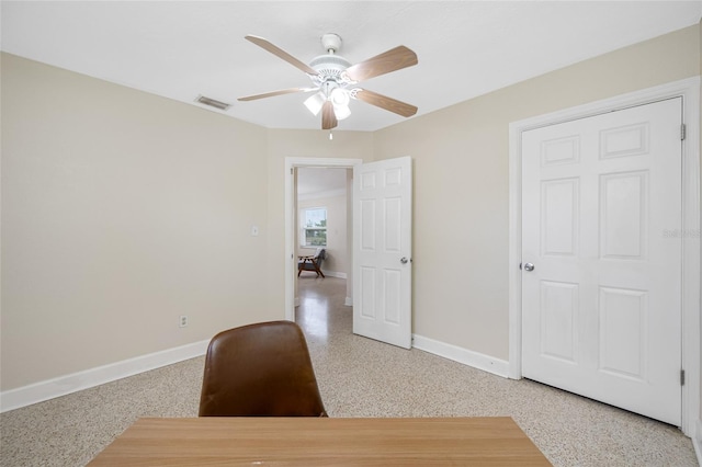 office with speckled floor, baseboards, a ceiling fan, and visible vents
