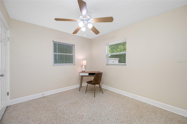 home office featuring speckled floor, baseboards, and ceiling fan