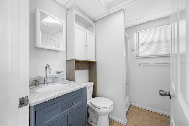 full bathroom featuring toilet, vanity, tile patterned flooring, and a stall shower