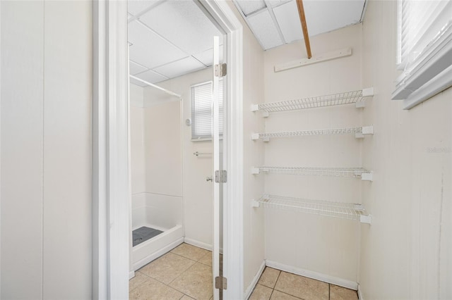 interior space with tile patterned floors and a shower stall