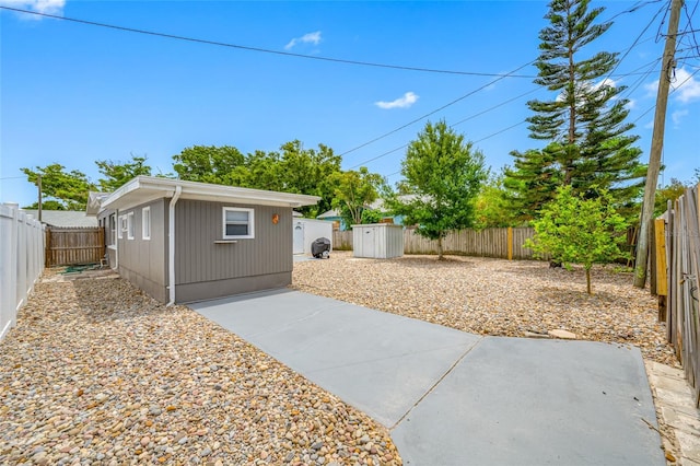 view of patio with an outdoor structure and a fenced backyard