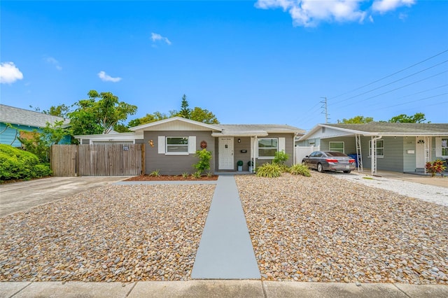bungalow-style home with fence and driveway