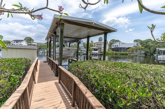 dock area featuring boat lift and a water view