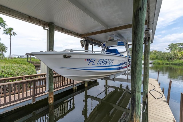 dock featuring boat lift and a water view