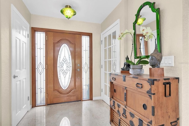 entrance foyer featuring light tile patterned floors and baseboards