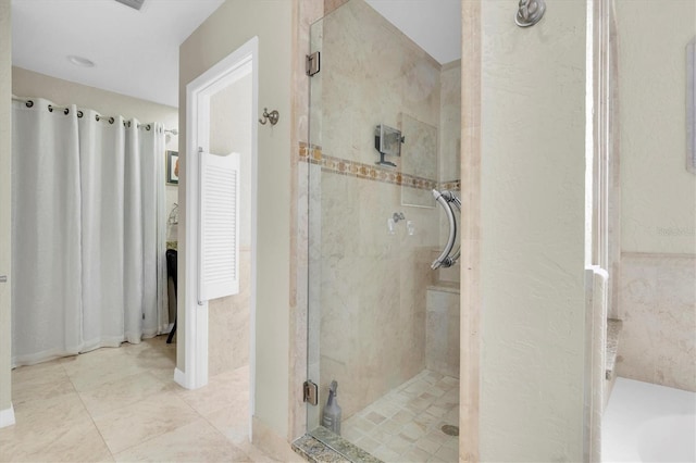 bathroom with a stall shower and a garden tub