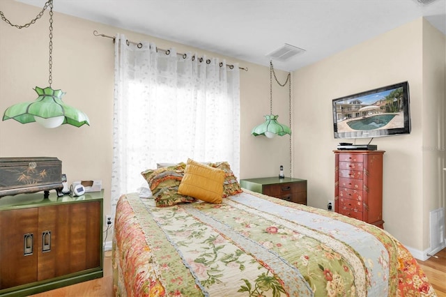 bedroom featuring wood finished floors and baseboards