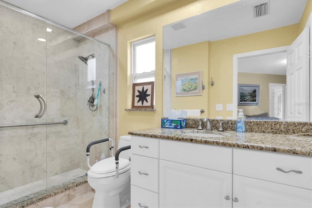 full bath with a stall shower, toilet, and vanity