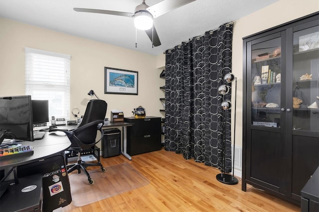 office with a ceiling fan and light wood-type flooring