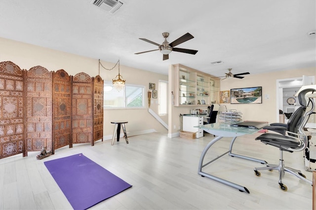 office area with ceiling fan and wood finished floors