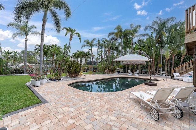 swimming pool featuring a patio and a yard